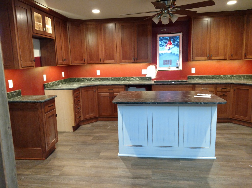Kitchen - large transitional u-shaped kitchen idea with recessed-panel cabinets, medium tone wood cabinets, granite countertops, multicolored backsplash, an island and multicolored countertops