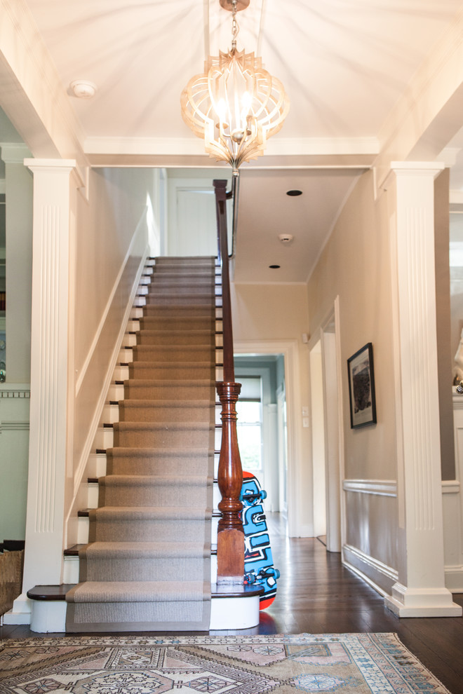 This is an example of a mid-sized eclectic foyer in New York with white walls, dark hardwood floors, a double front door, a metal front door and pink floor.