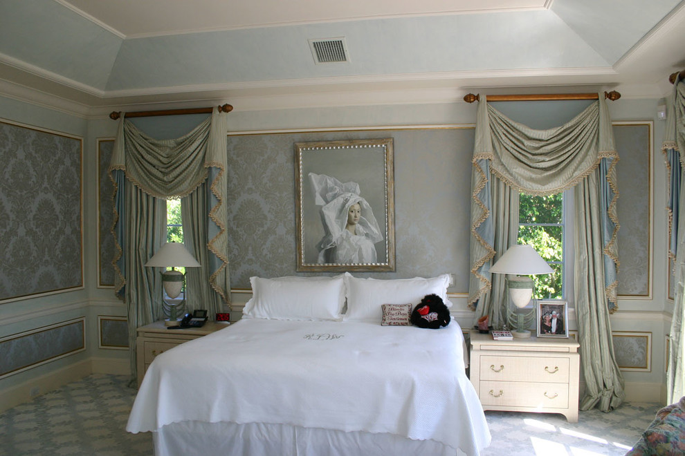 Example of a large classic master carpeted bedroom design in New York with gray walls and no fireplace