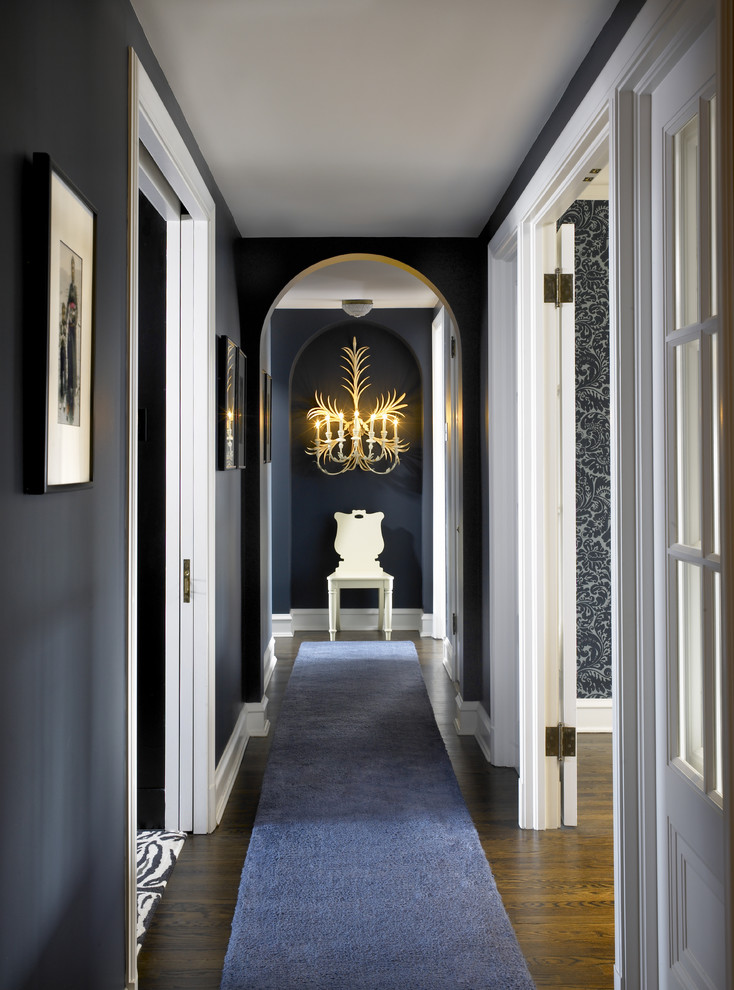 This is an example of an eclectic hallway in Chicago with grey walls and dark hardwood floors.