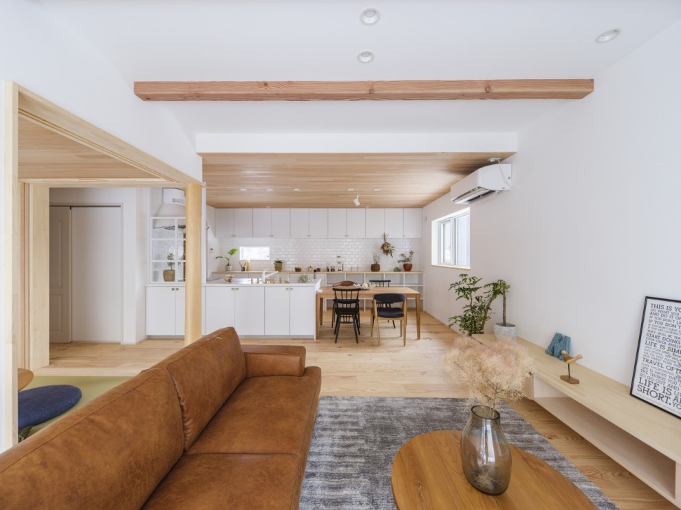 Inspiration for a medium sized scandinavian open plan living room in Other with white walls, light hardwood flooring, no fireplace, a freestanding tv, brown floors, exposed beams and wallpapered walls.
