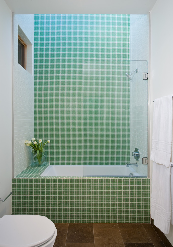 Photo of a mid-sized modern bathroom in San Francisco with mosaic tile, green tile, a shower/bathtub combo, white walls and limestone floors.