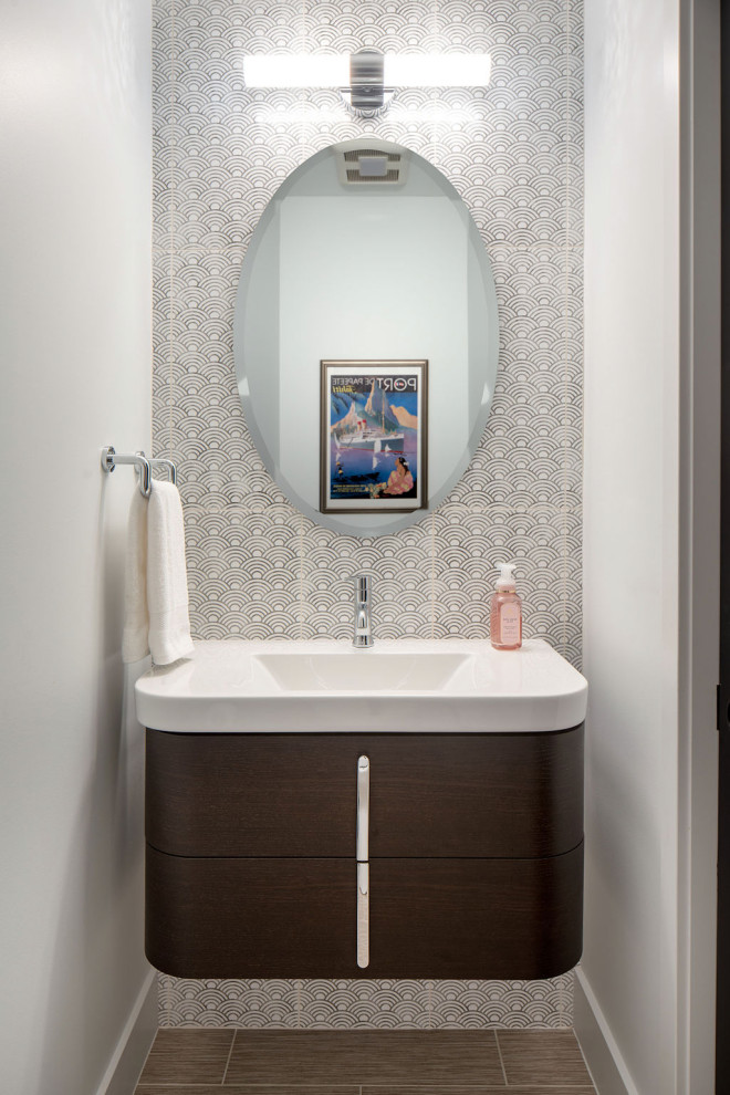 Small contemporary powder room in Columbus with flat-panel cabinets, dark wood cabinets, black and white tile, ceramic tile, white walls, porcelain floors, an integrated sink, solid surface benchtops, beige floor, white benchtops and a floating vanity.