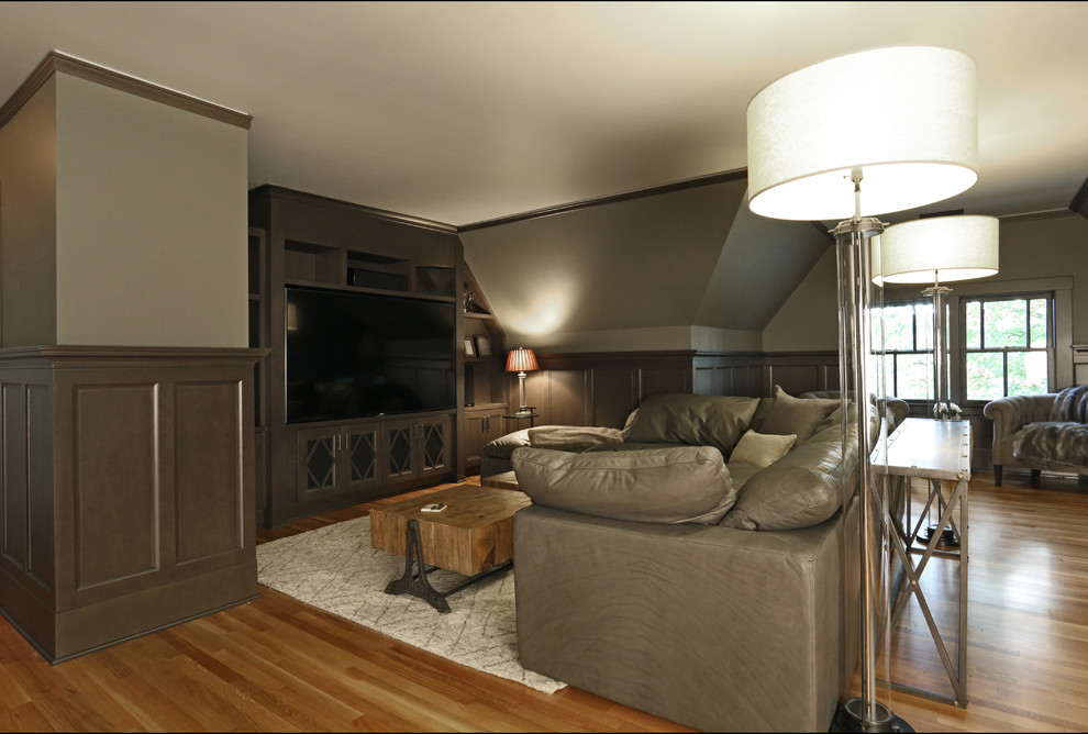 This is an example of a large arts and crafts open concept home theatre in Portland with brown walls, medium hardwood floors, a built-in media wall and brown floor.