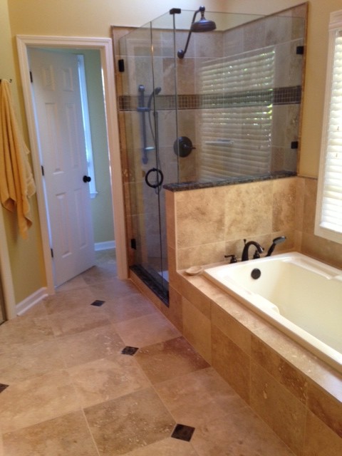 Photo of a large traditional master bathroom in Atlanta with a drop-in sink, raised-panel cabinets, beige cabinets, granite benchtops, a drop-in tub, an alcove shower, a two-piece toilet, beige tile, stone tile, beige walls and travertine floors.