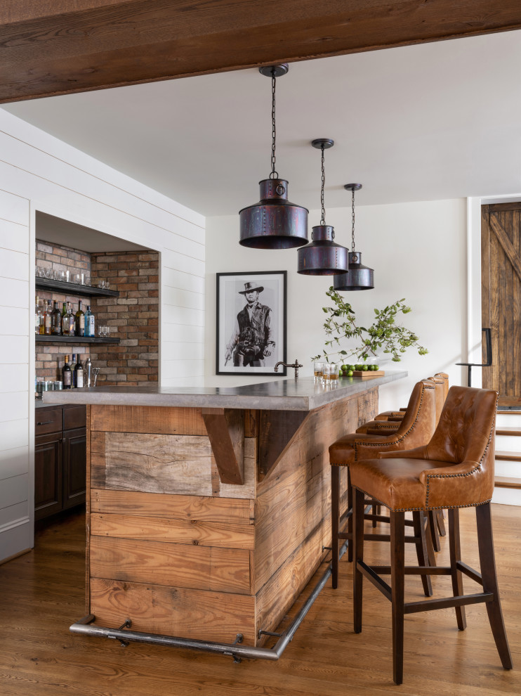 This is an example of a mid-sized country galley seated home bar in Atlanta with an undermount sink, concrete benchtops, brown splashback and brick splashback.