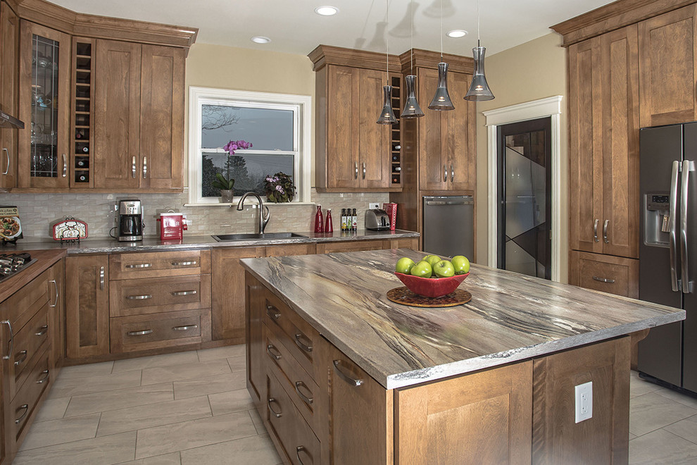 Inspiration for a large rustic u-shaped ceramic tile eat-in kitchen remodel with shaker cabinets, brown cabinets, beige backsplash, stainless steel appliances and an island