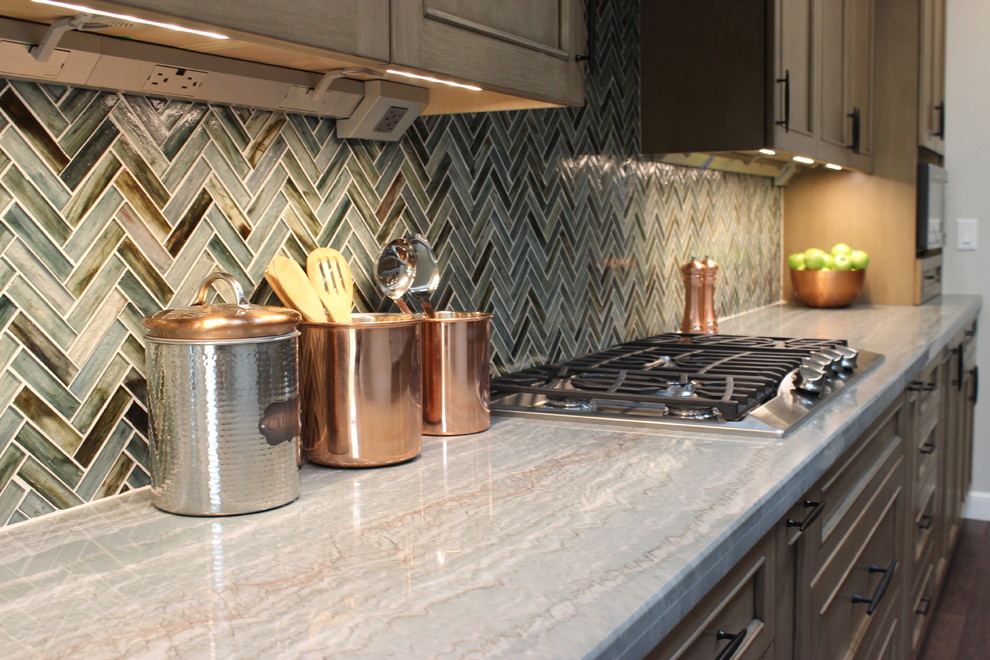 Exempel på ett mycket stort flerfärgad flerfärgat kök, med en enkel diskho, skåp i shakerstil, bruna skåp, bänkskiva i glas, flerfärgad stänkskydd, stänkskydd i glaskakel, rostfria vitvaror, en köksö och brunt golv