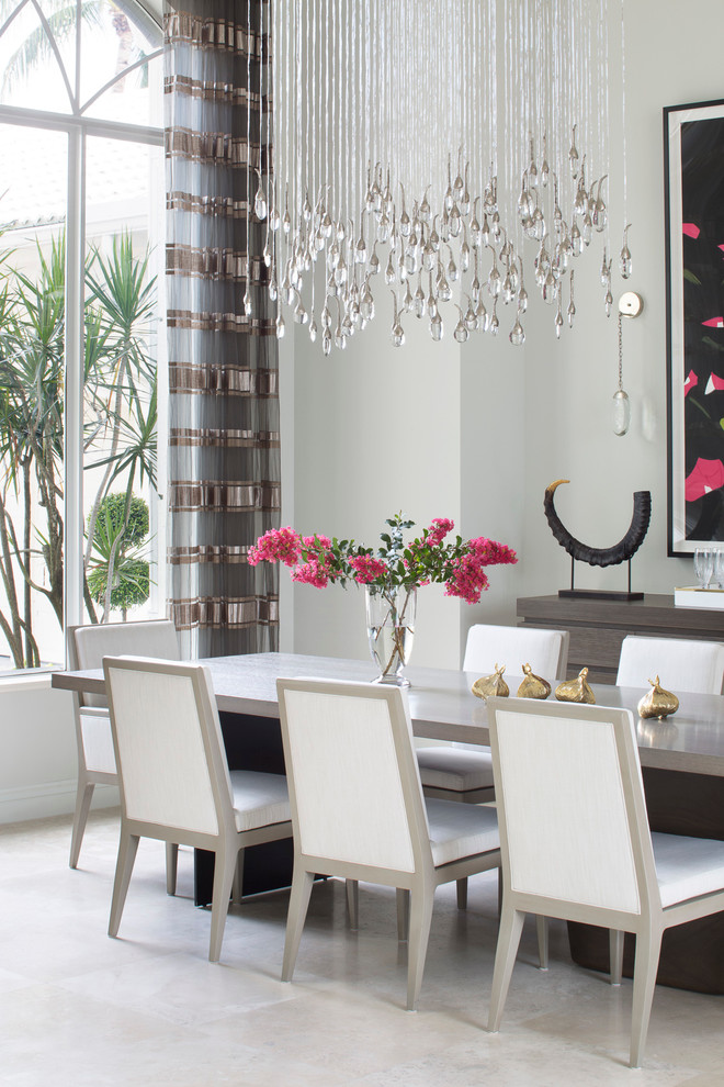 This is an example of an expansive transitional separate dining room in Miami with grey walls, porcelain floors and beige floor.