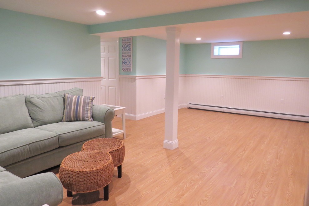 Photo of an expansive beach style look-out basement in Boston with blue walls, light hardwood floors and no fireplace.