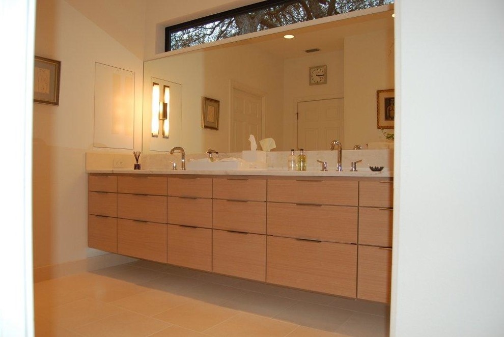 This is an example of a large contemporary master bathroom in Austin with flat-panel cabinets, light wood cabinets, beige walls and granite benchtops.