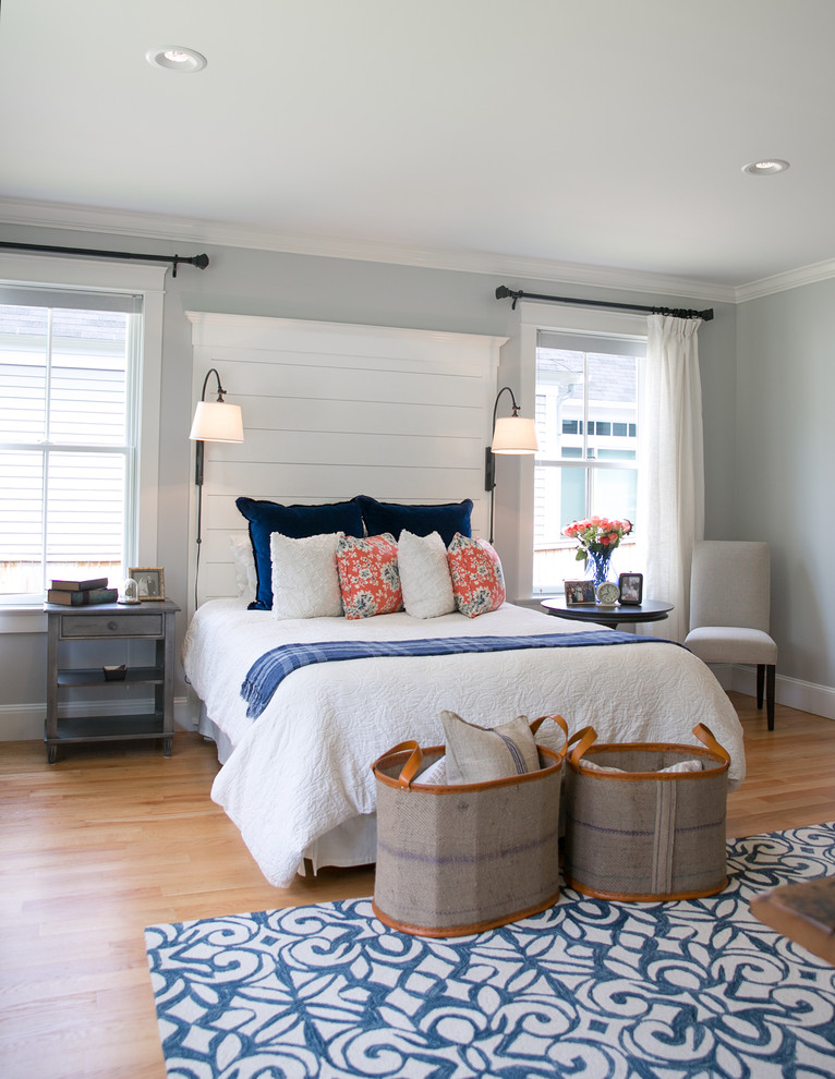 Inspiration for a mid-sized transitional master bedroom in Portland Maine with grey walls and light hardwood floors.