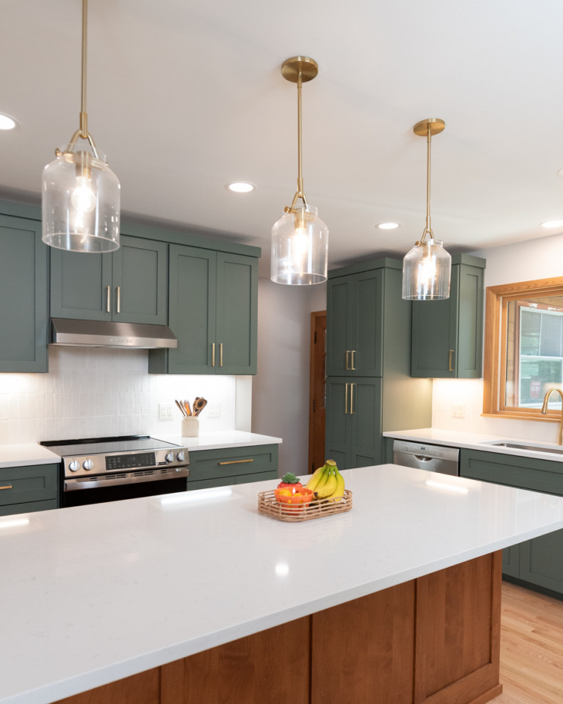 Kitchen - transitional light wood floor kitchen idea with shaker cabinets, green cabinets, quartz countertops, white backsplash, ceramic backsplash and an island