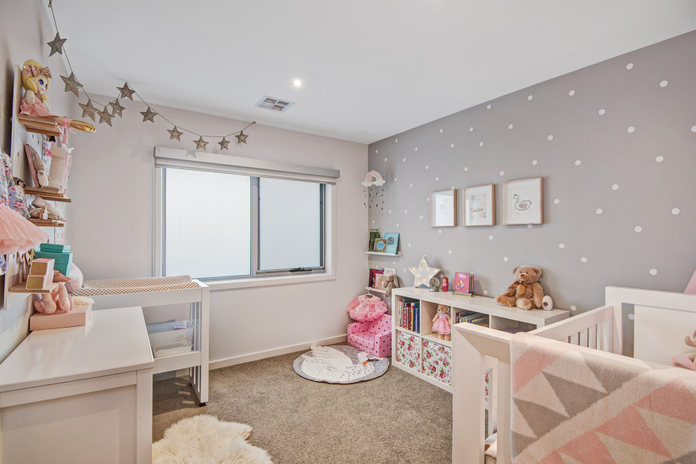 Large contemporary kids' room in Melbourne with carpet and grey floor for girls.