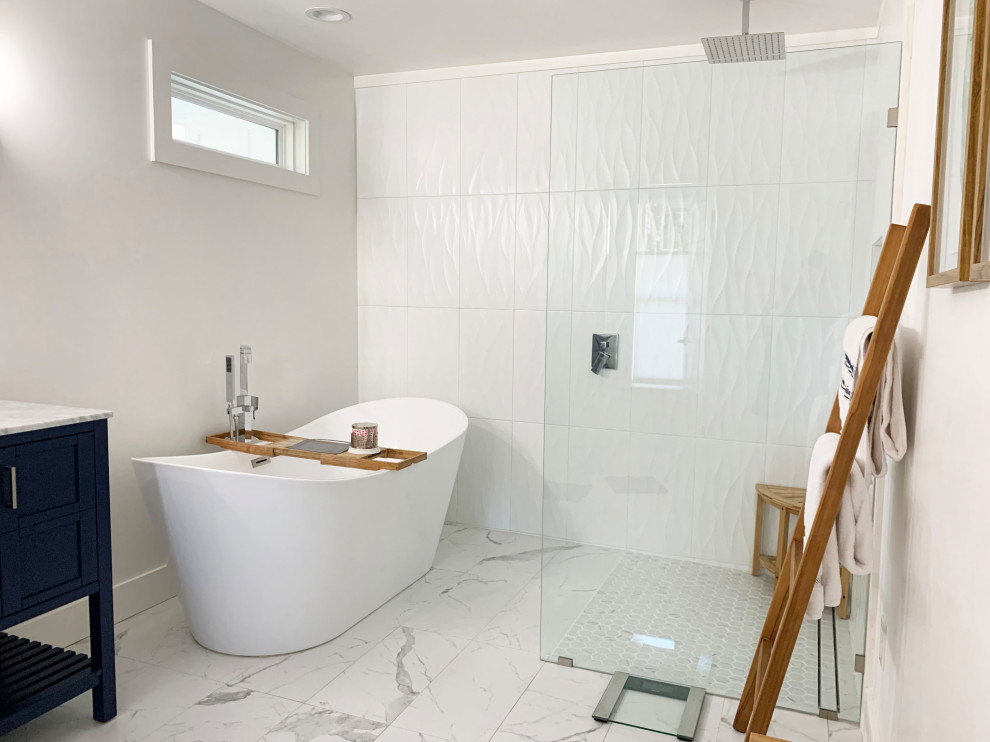 Design ideas for a mid-sized scandinavian master bathroom in Raleigh with blue cabinets, a freestanding tub, a curbless shower, porcelain floors, an open shower, a double vanity and a freestanding vanity.