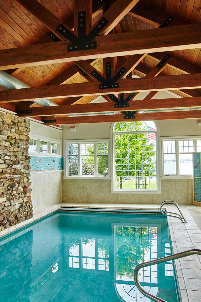 Inspiration for a large transitional backyard concrete paver and rectangular infinity pool remodel