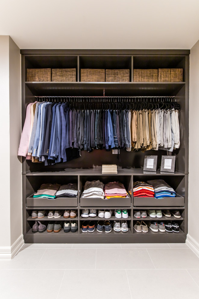 Mid-sized modern gender-neutral walk-in wardrobe in Dallas with flat-panel cabinets, grey cabinets, porcelain floors and grey floor.