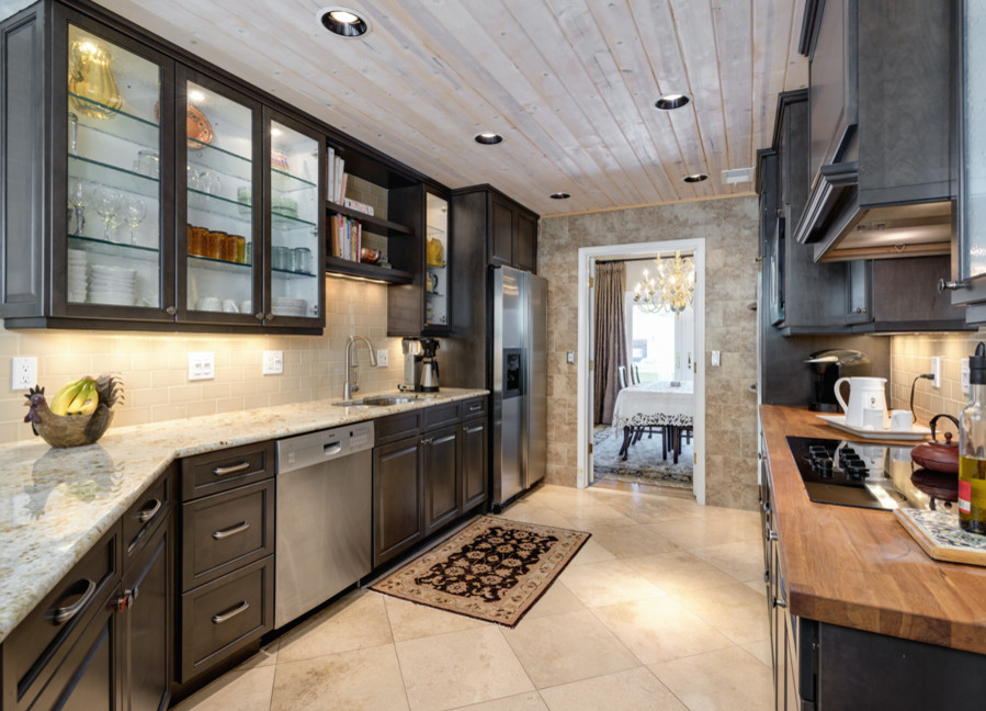 Enclosed kitchen - small contemporary galley travertine floor enclosed kitchen idea in Phoenix with a peninsula, an undermount sink, raised-panel cabinets, gray cabinets, granite countertops, beige backsplash, subway tile backsplash and stainless steel appliances