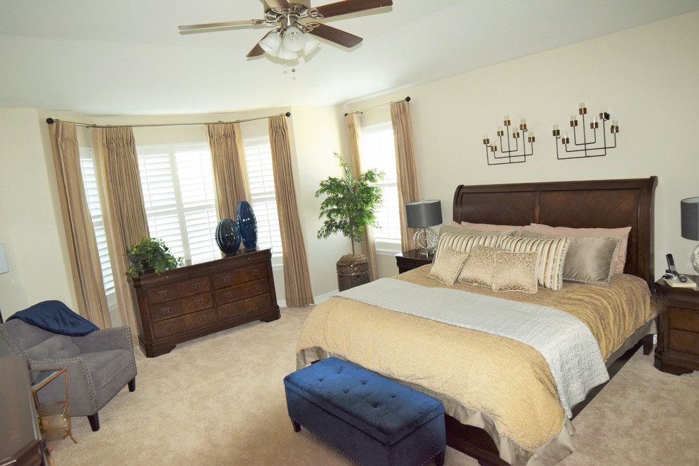 Photo of a large transitional master bedroom in Denver with grey walls and carpet.