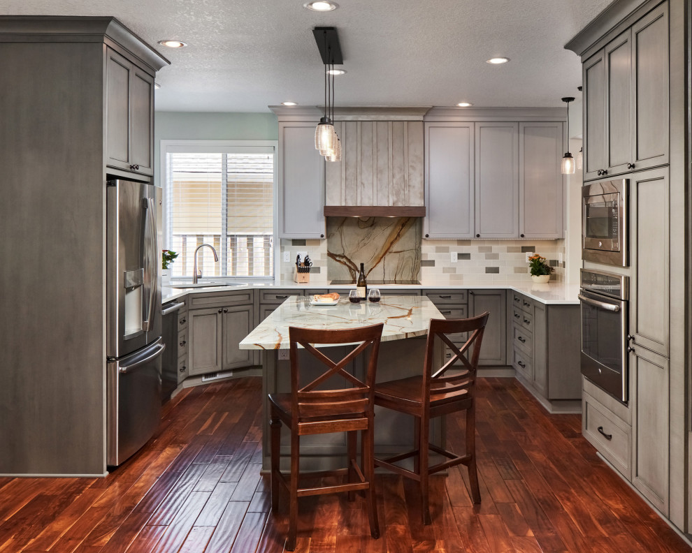 Design ideas for a mid-sized traditional single-wall eat-in kitchen in Portland with an undermount sink, shaker cabinets, grey cabinets, granite benchtops, stainless steel appliances, dark hardwood floors and with island.