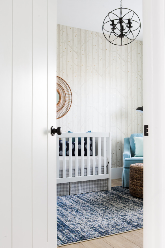 Example of a small transitional boy light wood floor nursery design in Salt Lake City with beige walls