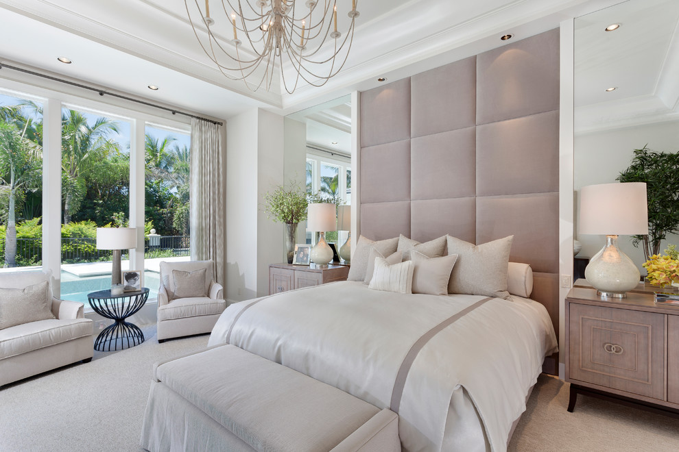 Beach style master bedroom in Miami with white walls, carpet and beige floor.