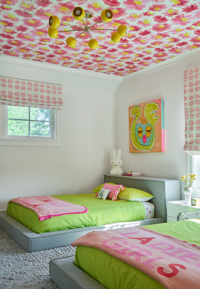 This is an example of a transitional kids' bedroom for kids 4-10 years old and girls in New York with white walls, carpet, grey floor and wallpaper.