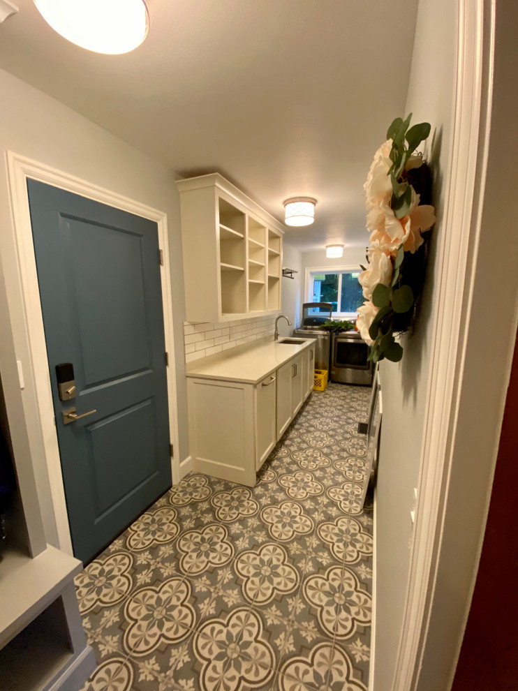 Inspiration for a mid-sized country l-shaped dedicated laundry room in Portland with an undermount sink, recessed-panel cabinets, white cabinets, quartz benchtops, blue walls, porcelain floors, a side-by-side washer and dryer, blue floor and beige benchtop.