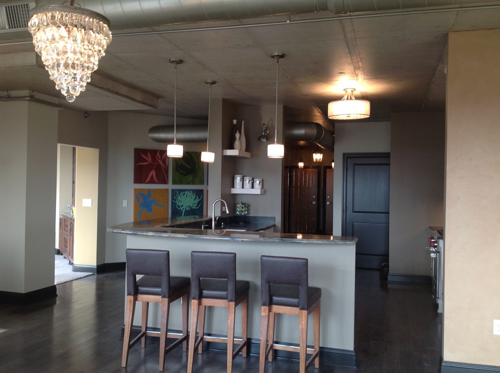 Inspiration for a large transitional galley medium tone wood floor eat-in kitchen remodel in Milwaukee with white cabinets, granite countertops, gray backsplash, stainless steel appliances, a peninsula, a double-bowl sink, recessed-panel cabinets and mirror backsplash