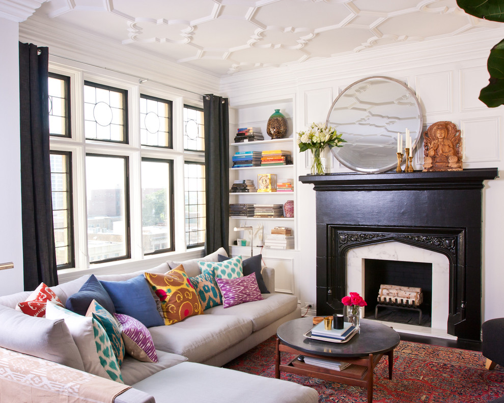 Small eclectic living room in Chicago with white walls, a standard fireplace and a stone fireplace surround.