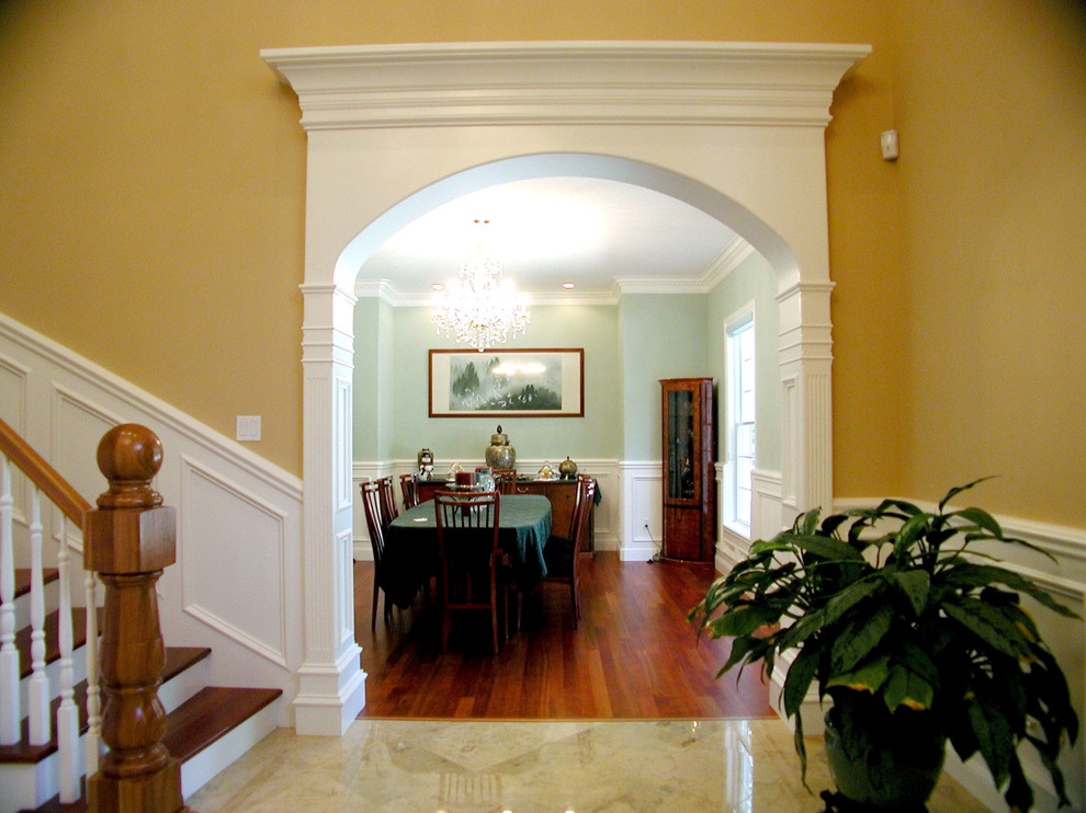Design ideas for a traditional entry hall in Portland with yellow walls and medium hardwood floors.