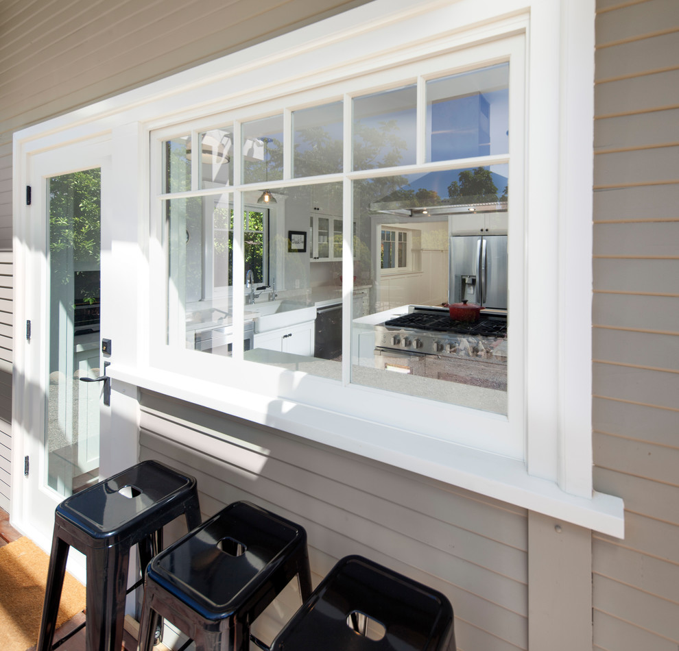 Inspiration for a large transitional u-shaped porcelain tile and gray floor enclosed kitchen remodel with a farmhouse sink, shaker cabinets, white cabinets, quartz countertops, multicolored backsplash, ceramic backsplash, stainless steel appliances, a peninsula and white countertops