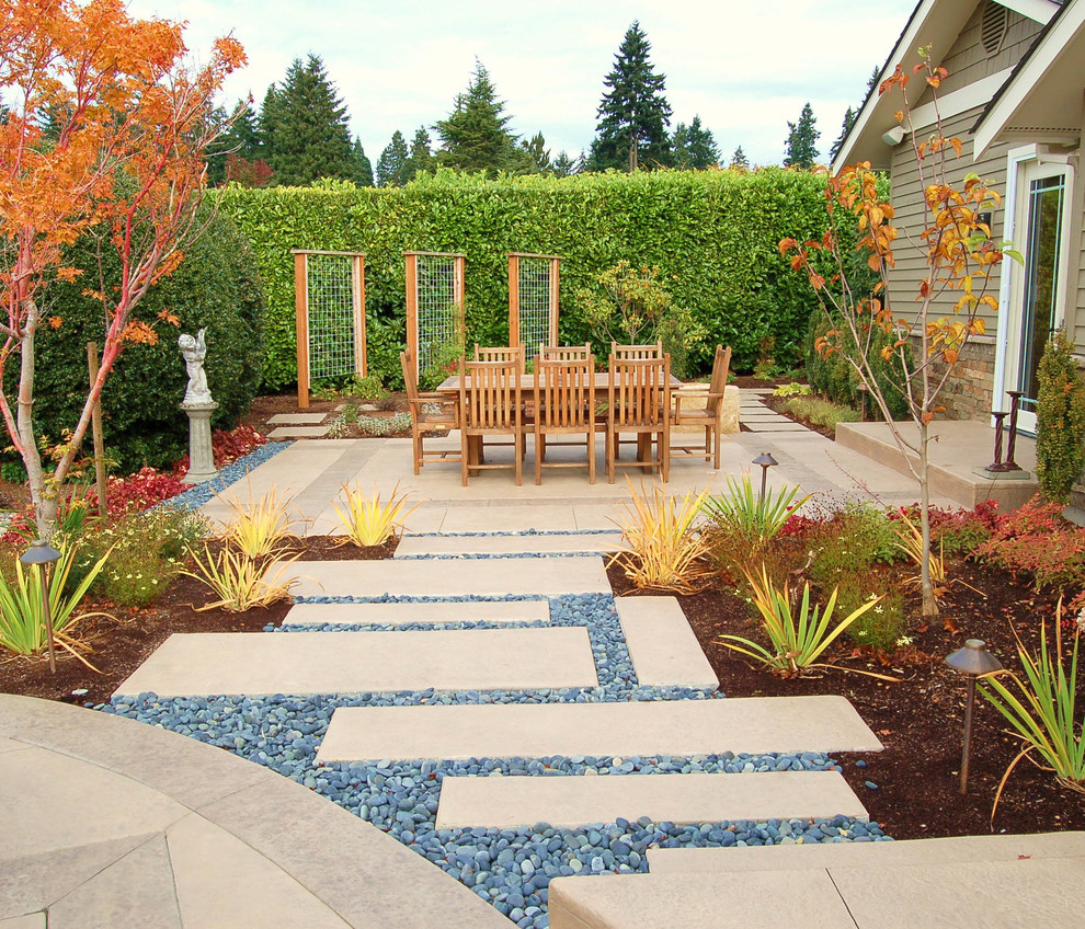 Large contemporary backyard patio in Seattle with concrete pavers, no cover and a vertical garden.