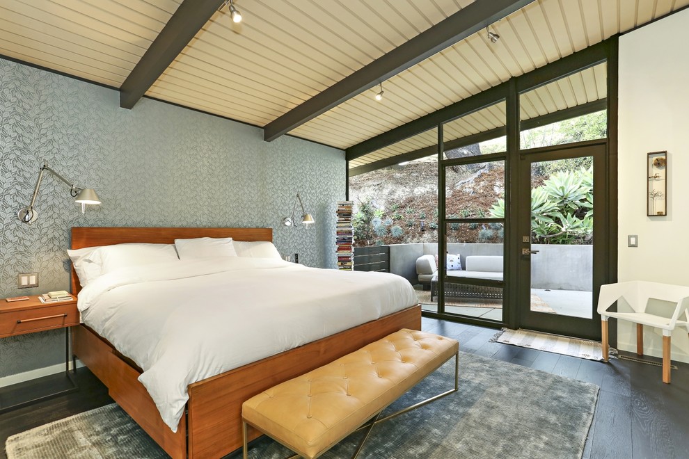 Design ideas for a midcentury bedroom in Los Angeles with blue walls, dark hardwood floors and black floor.