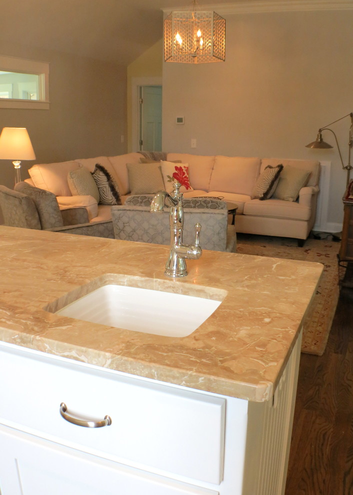 Example of a large transitional dark wood floor eat-in kitchen design with an undermount sink, white cabinets, marble countertops, white backsplash, glass sheet backsplash and an island