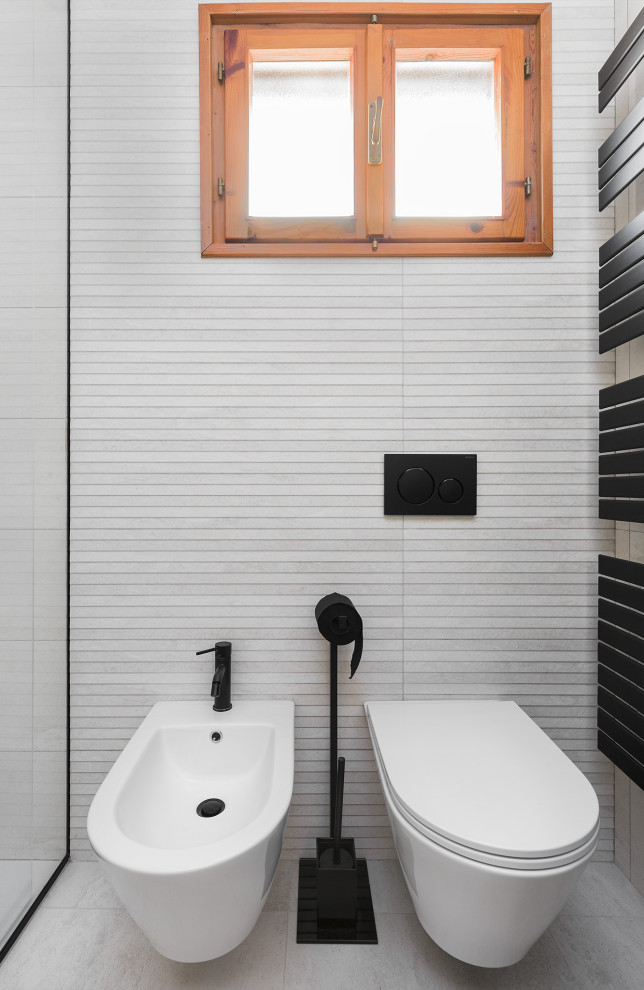 Powder room - small contemporary beige tile and ceramic tile porcelain tile and beige floor powder room idea in Other with beaded inset cabinets, gray cabinets, a wall-mount toilet, beige walls, an integrated sink, tile countertops, gray countertops and a floating vanity