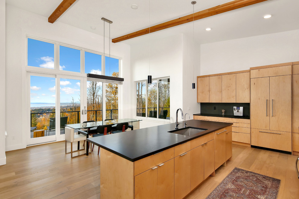 Inspiration for a mid-sized contemporary kitchen/dining combo in Seattle with white walls, light hardwood floors, no fireplace and brown floor.