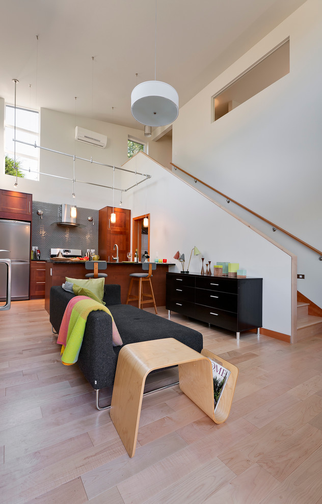 This is an example of a contemporary open plan kitchen in Seattle with a peninsula.
