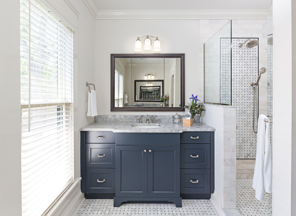 Mid-sized transitional master bathroom in Detroit with shaker cabinets, blue cabinets, a freestanding tub, an open shower, black and white tile, mosaic tile, white walls, marble floors, marble benchtops and an undermount sink.