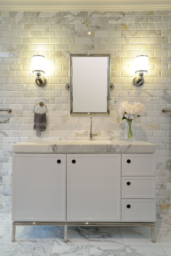 This is an example of a mid-sized contemporary 3/4 bathroom in San Francisco with flat-panel cabinets, white cabinets, a two-piece toilet, gray tile, white tile, subway tile, grey walls, marble floors and marble benchtops.