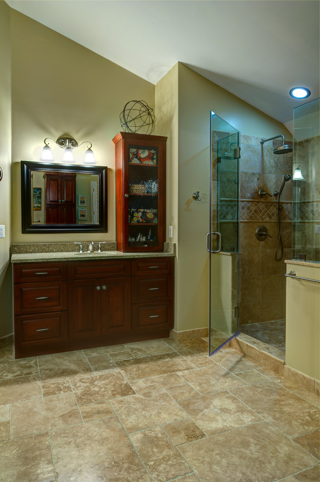 Inspiration for a large traditional master bathroom in DC Metro with an undermount sink, raised-panel cabinets, dark wood cabinets, engineered quartz benchtops, a corner shower, a one-piece toilet, beige tile, yellow walls and ceramic floors.