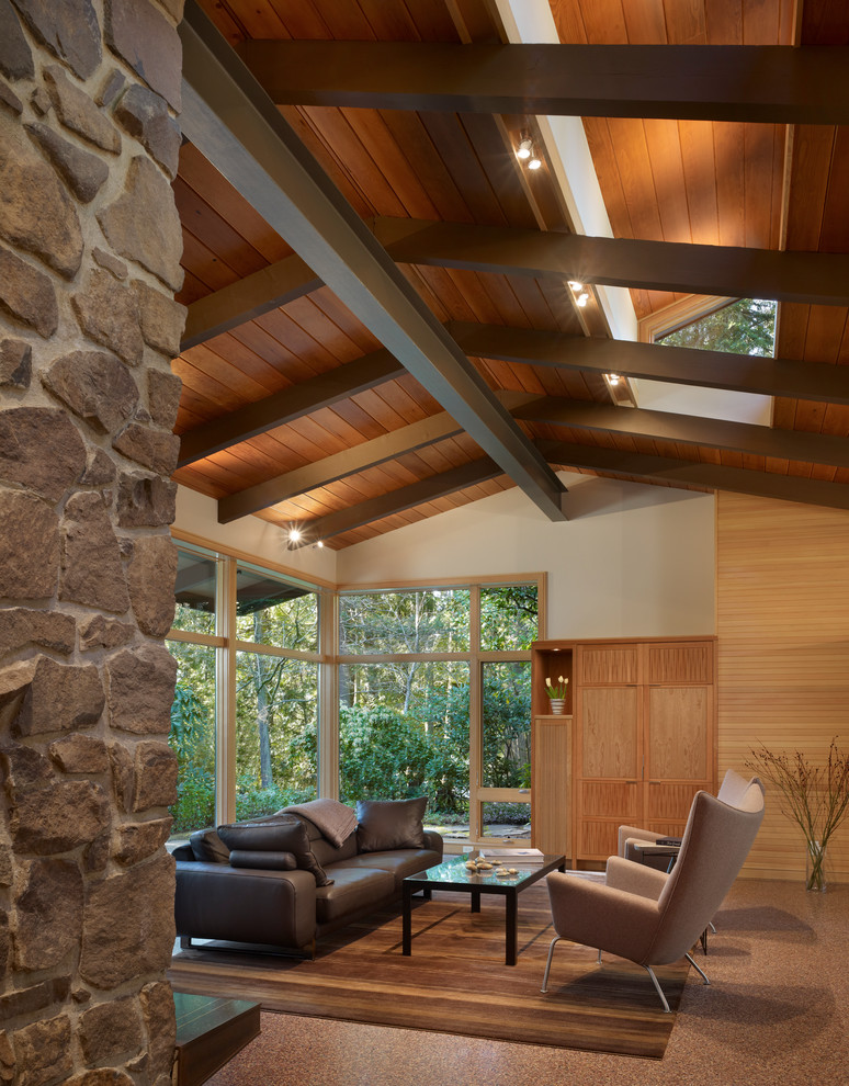 Photo of a mid-sized midcentury open concept living room in Seattle with beige walls and a concealed tv.