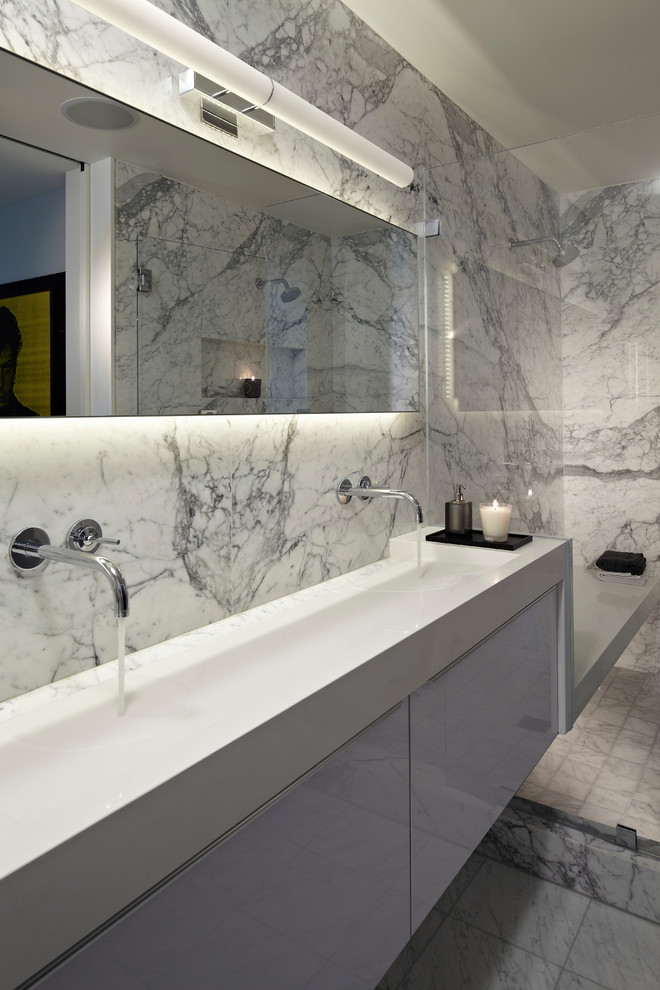Photo of a contemporary bathroom in Los Angeles with a trough sink, flat-panel cabinets, white cabinets and white tile.