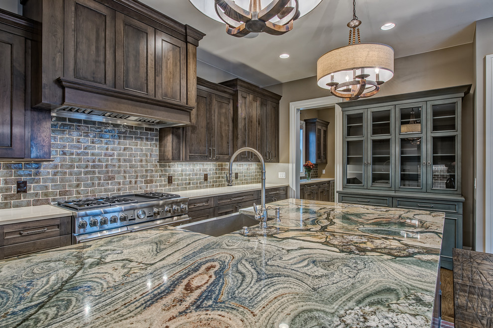 Large transitional u-shaped dark wood floor open concept kitchen photo in Denver with a farmhouse sink, raised-panel cabinets, dark wood cabinets, granite countertops, gray backsplash, subway tile backsplash, stainless steel appliances and an island