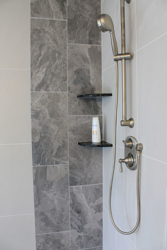 Design ideas for a large traditional master bathroom in New York with a drop-in tub, a corner shower, grey walls, gray tile, porcelain tile and porcelain floors.
