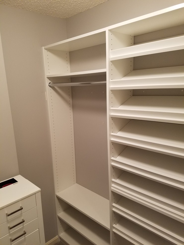 Photo of a small traditional gender-neutral walk-in wardrobe in Louisville with open cabinets, white cabinets, carpet and brown floor.