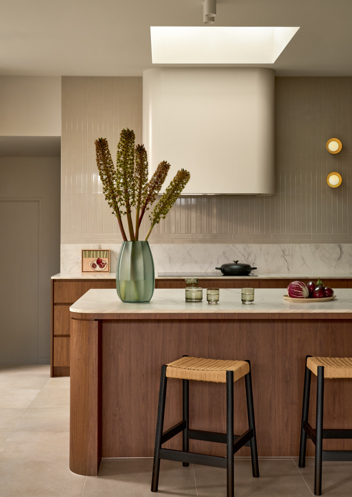This is an example of an expansive midcentury l-shaped open plan kitchen in Sydney with a double-bowl sink, flat-panel cabinets, medium wood cabinets, porcelain floors and with island.