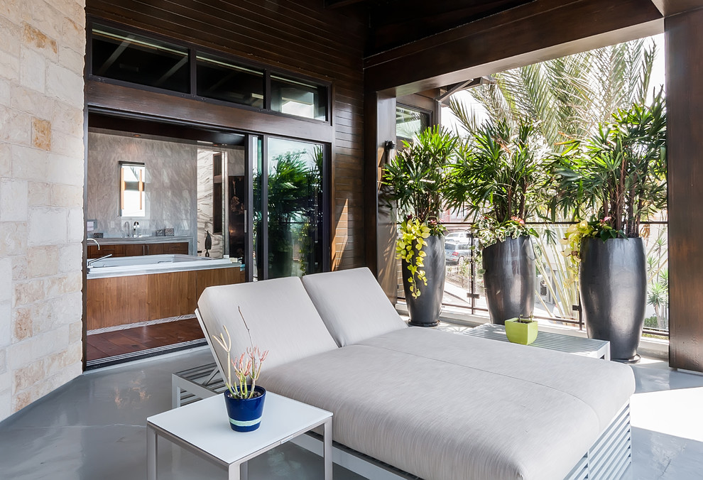 Expansive contemporary rooftop deck in Los Angeles with an outdoor shower and a roof extension.