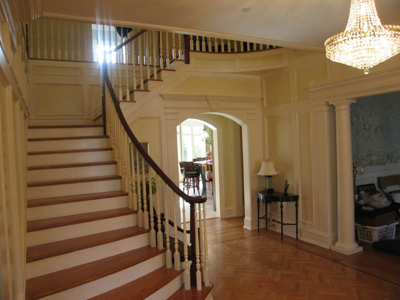 Design ideas for a mid-sized traditional wood l-shaped staircase in New York with wood risers.