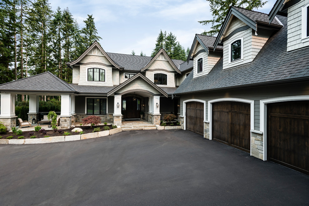 Inspiration for an expansive traditional three-storey grey house exterior in Vancouver with mixed siding, a gable roof and a shingle roof.